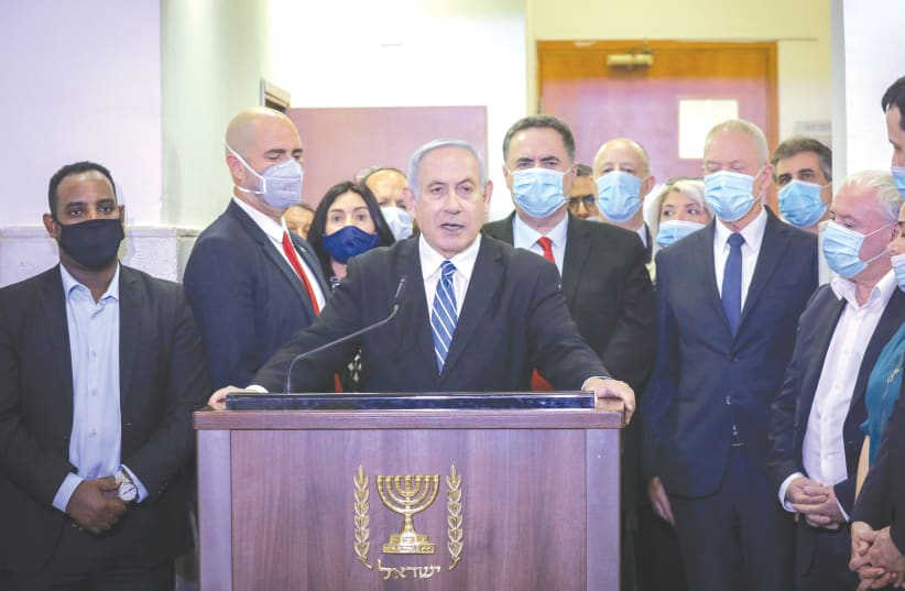 Prime Minister Benjamin Netanyahu delivers a statement before entering the district courtroom where he is facing a trial for alleged corruption crimes, in Jerusalem last May. (photo credit: YONATAN SINDEL/POOL)