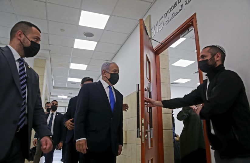 Prime Minister Benjamin Netanyahu is seen entering the courtroom at the Jerusalem District Court for his hearing. (photo credit: OREN BEN HAKOON/POOL)