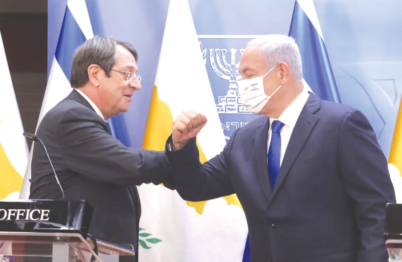 PRIME MINISTER Benjamin Netanyahu and Cypriot President Nicos Anastasiades bump elbows during their meeting in Jerusalem in February. (photo credit: MARC ISRAEL SELLEM/THE JERUSALEM POST)