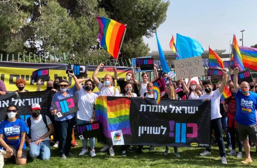 People wave signs saying "Israel says yes to equality at an LGBTQ+ demonstration. (photo credit: THE AGUDAH – THE ASSOCIATION FOR LGBTQ EQUALITY IN ISRAEL)