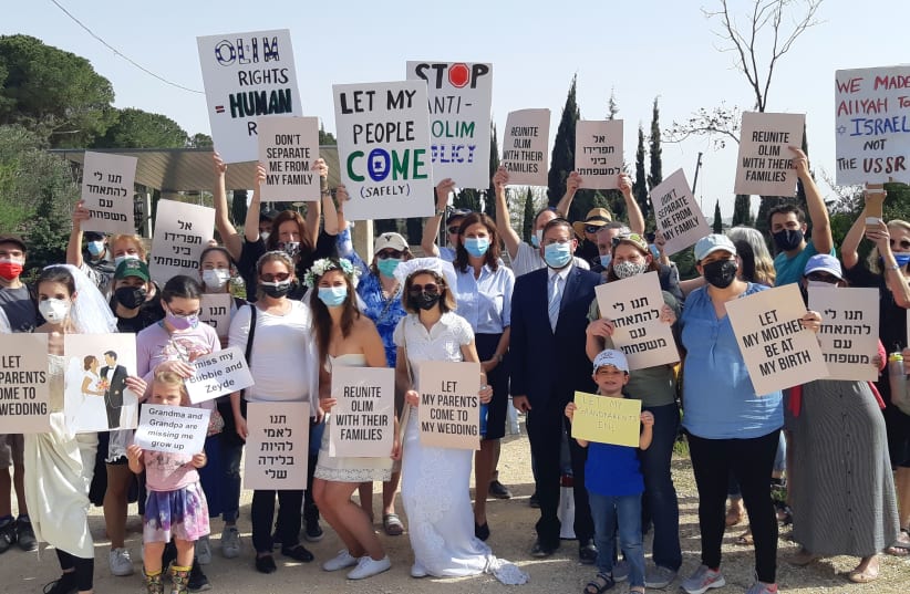 Former MK Dov Lipman and outgoing MK Michal Cotler-Wunsh together with around 30 activists demand greater consideration for immigrants at a protest outside the Knesset Tuesday afternoon. (photo credit: JEREMY SHARON)