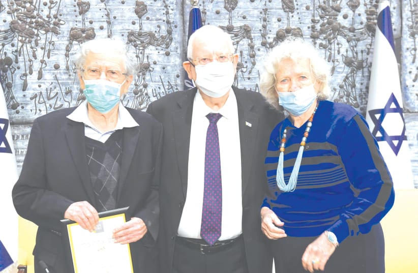 PRESIDENT REUVEN RIVLIN, flanked by Prof. Aharon Barak and his wife, Elisheva. (photo credit: MARK NEYMAN/GPO)