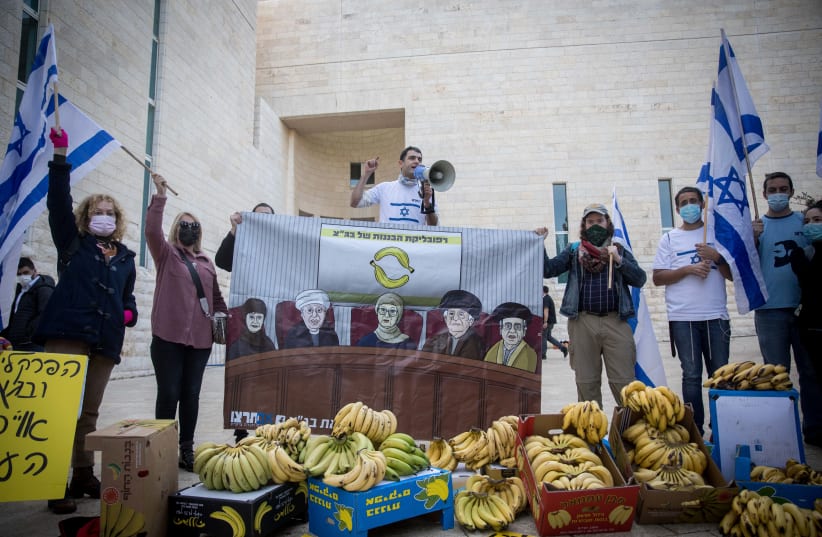 Members of the "Im Tirzu" movement protest outside a court hearing on petitions against the Jewish Nation-State Law, at the Supreme Court in Jerusalem on December 22, 2020 (photo credit: YONATAN SINDEL/FLASH 90)
