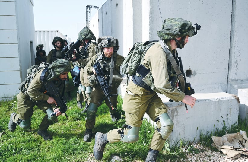 SOLDIERS TRAIN on the Golan Heights on Wednesday. (photo credit: MICHAEL GILADI/FLASH90)