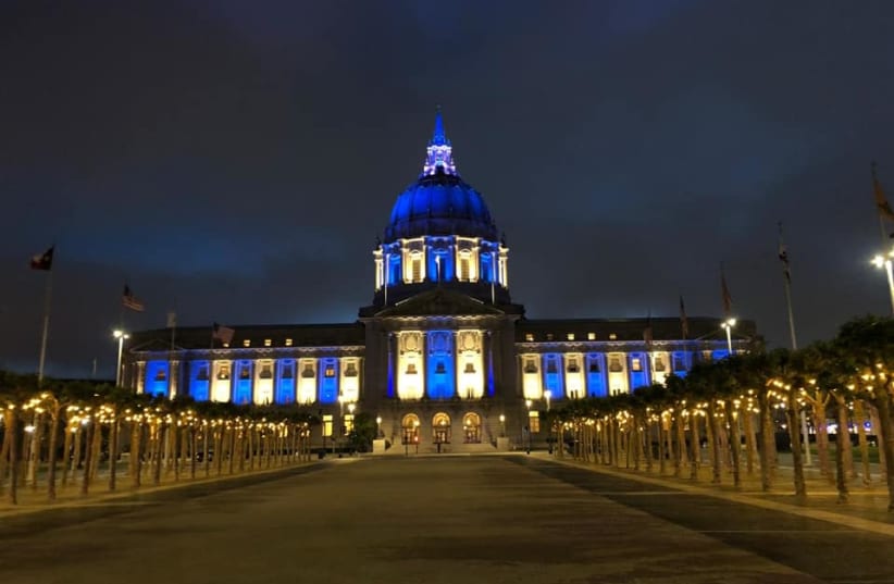 The San Francisco City Hall is seen lit up in blue and white. (photo credit: SHANIE ROTH)