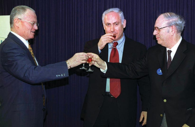 PRIME MINISTER Benjamin Netanyahu joins Halevy as he succeeds outgoing Mossad chief Danny Yatom in a toast at the Prime Minister’s Office during the Mossad handover ceremony April 8, 1998 (photo credit: REUTERS)