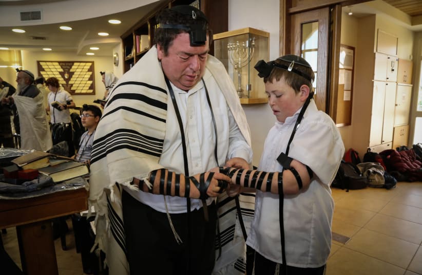 WOMEN ARE exempt from the time-bound mitzvah of tefillin (photo credit: GERSHON ELINSON/FLASH90)