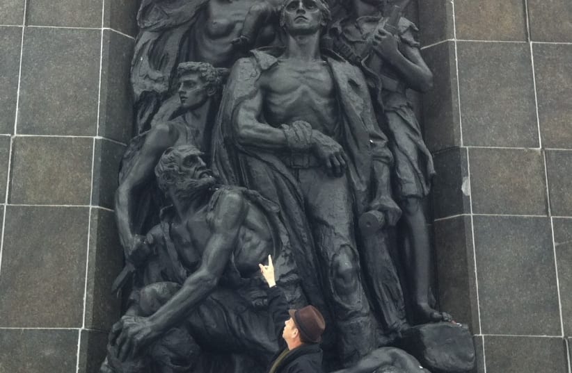 Ofer Aloni visiting Nathan Rappaport's Monument to the Ghetto Heroes in Warsaw, depicting a young woman believed to be Rachel Sarenka Zylberberg (photo credit: Courtesy)