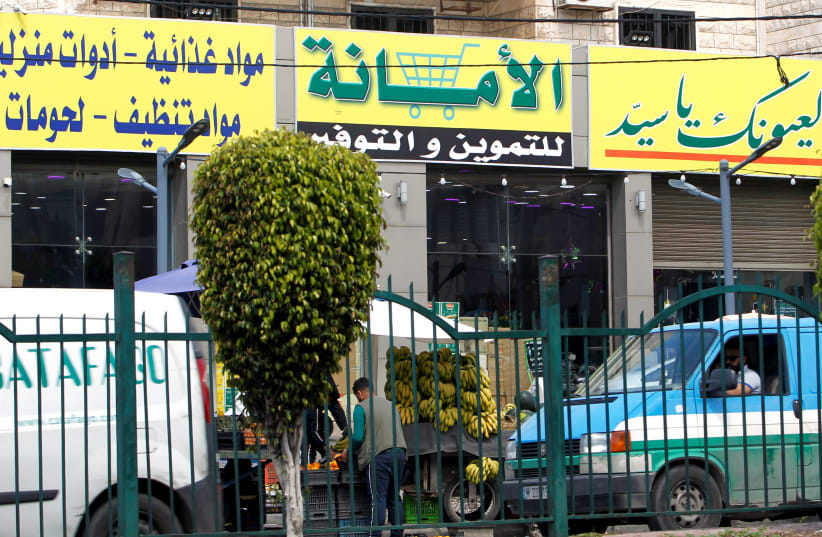 A view shows a market for groceries with a Hezbollah slogan on it, in Beirut suburbs, Lebanon April 16, 2021. (photo credit: REUTERS/STRINGER)