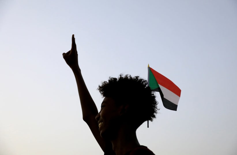 A Sudanese demonstrator, seeking to revive a push for civilian rule in ongoing tumult since the overthrow of former President Omar al-Bashir more than two months ago, makes a victory sign during a demonstration in Khartoum, Sudan, June 27, 2019 (photo credit: REUTERS/UMIT BEKTAS/FILE PHOTO)