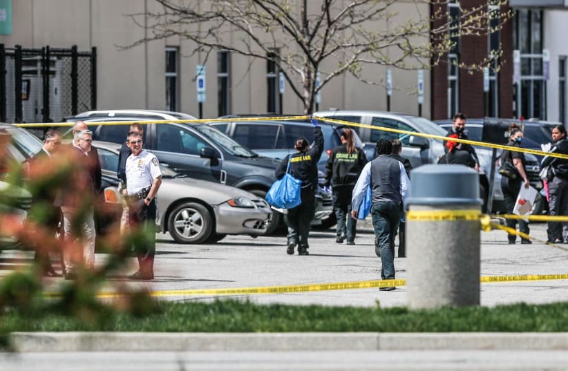 Investigators are on the scene following a mass shooting at a FedEx facility in Indianapolis, Indiana, U.S., April 16, 2021. (photo credit: MICHELLE PEMBERTON-USA TODAY NETWORK VIA REUTERS)