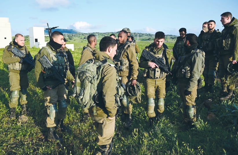 SOLDIERS GATHER during a training exercise on the Golan Heights last week. (photo credit: MICHAEL GILADI/FLASH90)