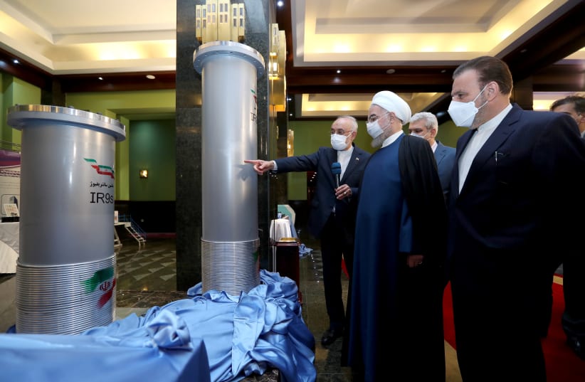 former Iranian president Hassan Rouhani reviews Iran's new nuclear achievements during Iran's National Nuclear Energy Day in Tehran, Iran April 10, 2021. (photo credit: IRANIAN PRESIDENCY OFFICE/WANA (WEST ASIA NEWS AGENCY)/HANDOUT VIA REUTERS)