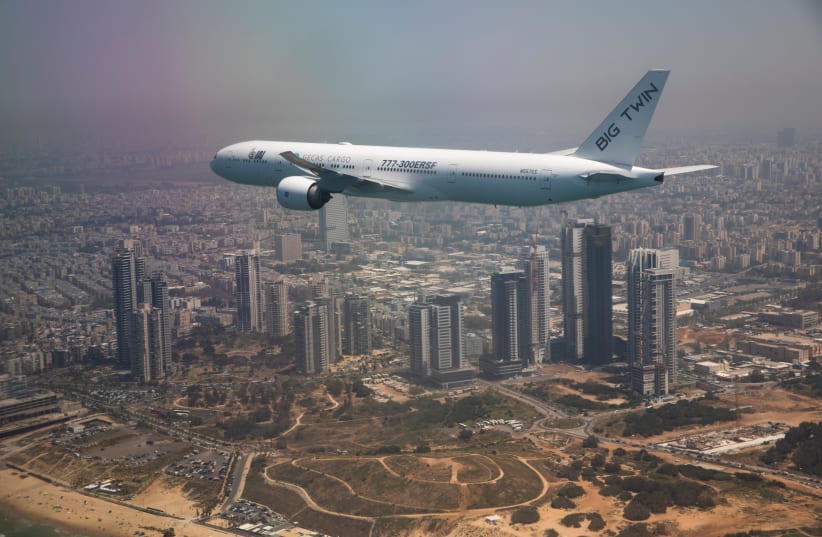 An IAI cargo Boeing 777 flies over Tel Aviv during a flyover by IAI (Israel Aerospace Industries) planes on Israel's Independence Day, which marks the 73rd anniversary of the creation of the state, Israel April 15, 2021. (photo credit: AMIR COHEN/REUTERS)