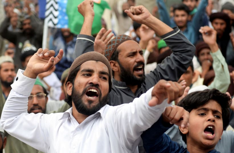 Supporters of the Tehreek-e-Labaik Pakistan (TLP) Islamist political party chant slogans as they protest against the arrest of their leader in Lahore, Pakistan April 16, 2021 (photo credit: REUTERS/STRINGER)