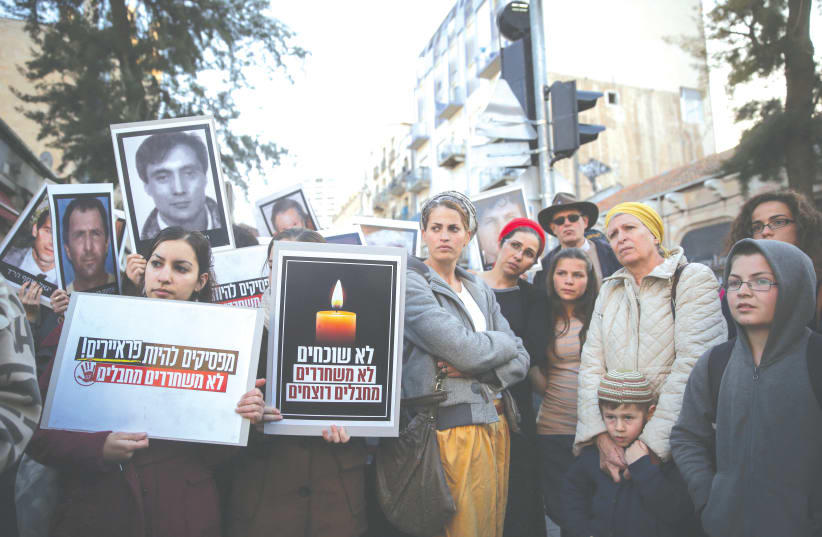 MEMBERS OF the Fogel Family (right) protest the release of Palestinian prisoners, in 2014.  (photo credit: HADAS PARUSH/FLASH90)