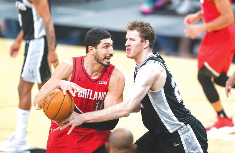 PORTLAND TRAIL Blazers center Enes Kanter (11) drives toward the basket against San Antonio Spurs center Jakob Poeltl in a game at the AT&T Center in San Antonio, Texas, earlier this week. (photo credit: DANIEL DUNN/USA TODAY SPORTS/REUTERS)