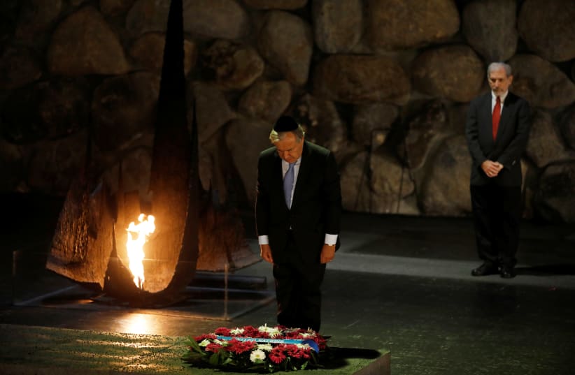 UN Secretary-General António Guterres, observes a moment of silence during a ceremony commemorating the six million Jews killed by the Nazis in the Holocaust in the Hall of Remembrance, Yad Vashem, August 2017 (photo credit: REUTERS/RONEN ZEVULUN/FILE PHOTO)