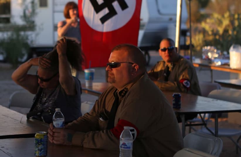 Burt Colucci of the white nationalist group National Socialist Movement attends a rally in Maricopa, Arizona, U.S., April 16, 2021. (photo credit: JIM URQUHART/REUTERS)