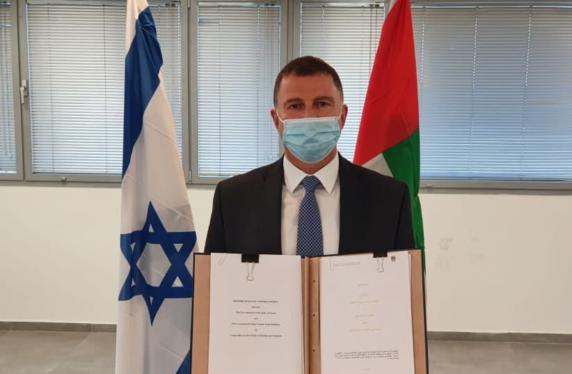 Health Minister Yuli Edelstein is seen with a signed agreement with the UAE for medical cooperation. (photo credit: HEALTH MINISTRY)