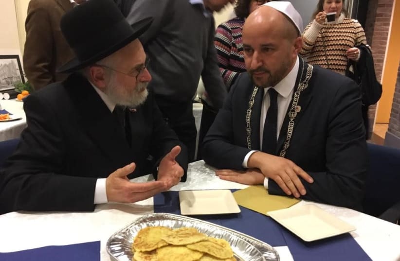 Dutch Chief Rabbi Binyomin Jacobs is seen with Arnhem Mayor Ahmed Marcouch at the Arnhem synagogue. (photo credit: RABBI JACOBS)