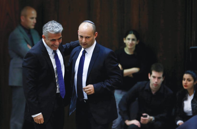 YAIR LAPID (left) and Naftali Bennett share a smile at the Knesset in 2013. (photo credit: BAZ RATNER/REUTERS)