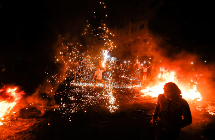 Palestinians protest during an anti-Israel protest over tension in Jerusalem, in Gaza City, April 24, 2021. (photo credit: ATIA MOHAMMED/FLASH90)