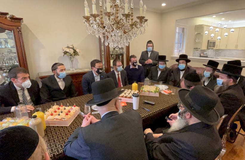 New York City mayoral candidate Andrew Yang, top, third from left, meets with haredi Orthodox Jewish leaders in Borough Park, Brooklyn, in an undated photo supplied by his campaign. (photo credit: YANG FOR NEW YORK)