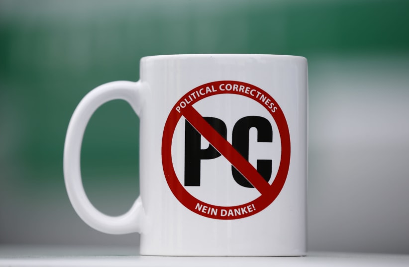 A MUG with text ‘Political correctness – No thank you!’ is pictured at a 2016 conference in Stuttgart, Germany. The Canadian Peterson undertakes a sophisticated deconstruction of aspects of being PC. (photo credit: WOLFGANG RATTAY / REUTERS)