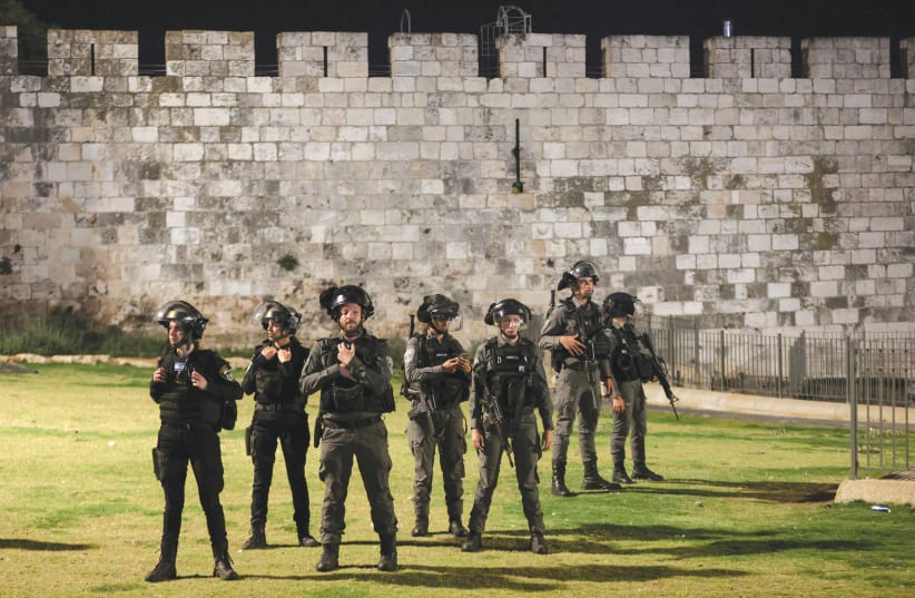POLICE OFFICERS stand by the walls of Jerusalem’s Old City amid tension with Palestinians during Ramadan earlier this week. (photo credit: RONEN ZVULUN / REUTERS)