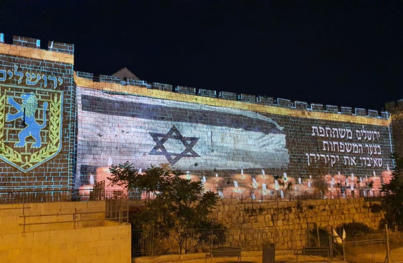 Jerusalem's Old City walls light up in solidarity with the victims of the Mount Meron tragedy, May 2021. (photo credit: RON TOBOL)