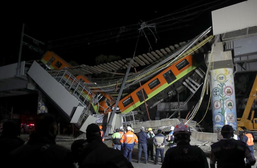 The site where an overpass for a metro partially collapsed with train cars on it is seen at Olivos station in Mexico City, Mexico, May 4, 2021 (photo credit: REUTERS/HENRY ROMERO)