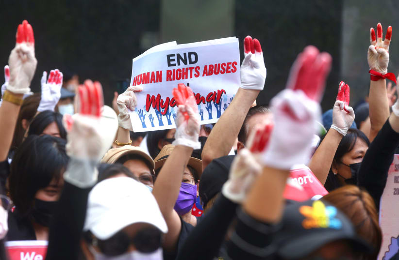 Protesters flash a three-finger salute during a march to protest against Myanmar military coup, in Taipei (photo credit: ANN WANG / REUTERS)