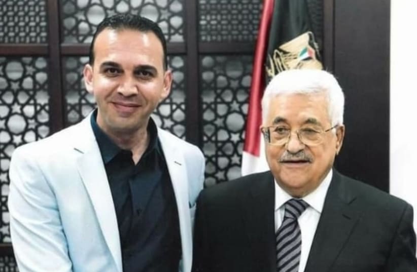 Palestinian journalist Hassan al-Najjar is seen shaking hands with PA President Mahmoud Abbas. (photo credit: Courtesy)