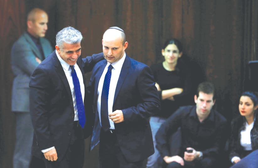 YAIR LAPID (left) walks with Naftali Bennett at the Knesset in Jerusalem in 2013. (photo credit: BAZ RATNER/REUTERS)
