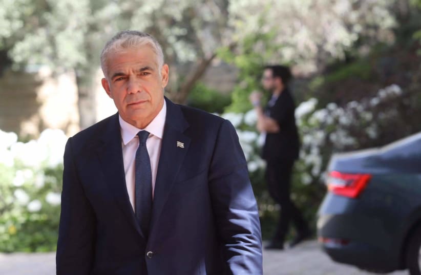 Opposition leader and Yesh Atid chairman Yair Lapid arrives at the President's Residence, May 5, 2021. (photo credit: MARC ISRAEL SELLEM/THE JERUSALEM POST)
