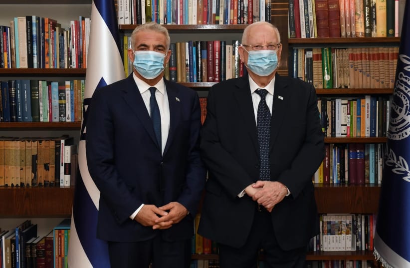 Yesh Atid leader Yair Lapid (L) pictured next to President Reuven Rivlin (photo credit: AVI KENNER/GPO)