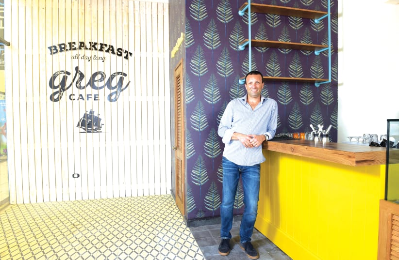 YAIR MALKA, owner and founder of Café Greg, stands outside one of his branches. (photo credit: ELAD GUTMAN)