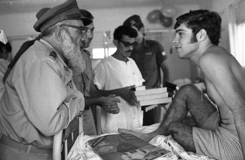 IDF CHIEF rabbi Shlomo Goren with a wounded soldier, 1969 (photo credit: Wikimedia Commons)