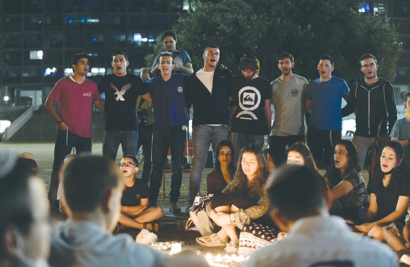 A CROWD at Rabin Square in Tel Aviv lights candles on Sunday for the 45 victims who died in a crush during Lag Ba’omer celebrations at Mount Meron. (photo credit: TOMER NEUBERG/FLASH90)