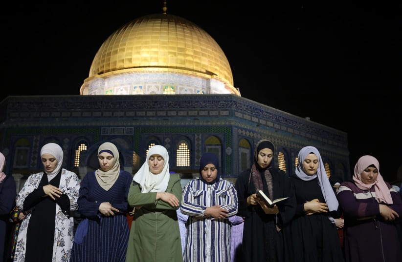 Palestinians pray on Laylat al-Qadr during the holy month of Ramadan, at the compound that houses Al-Aqsa Mosque, known to Muslims as Noble Sanctuary and to Jews as Temple Mount, in Jerusalem's Old City, May 8, 2021 (photo credit: REUTERS/AMMAR AWAD)