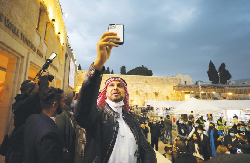 A MEMBER of a delegation from the United Arab Emirates takes a selfie at the Western Wall last year. (photo credit: AMMAR AWAD/REUTERS)