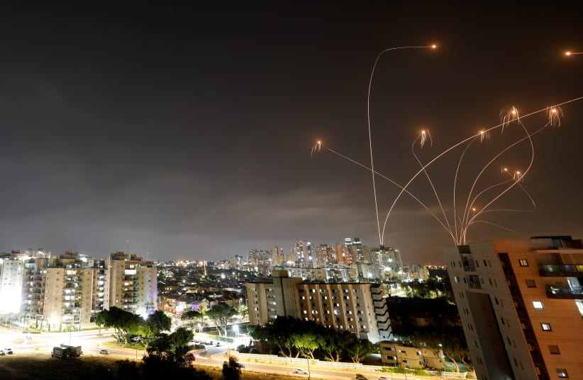 Streaks of light are seen as Israel's Iron Dome anti-missile system intercepts rockets launched from the Gaza Strip towards Israel, as seen from Ashkelon, Israel May 10, 2021 (photo credit: REUTERS/AMIR COHEN)