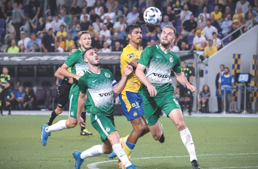 AFTER RALLYING from a two-goal deficit to draw Maccabi Tel Aviv, Maccabi Haifa has a strong hold on first place with just three games left in the season. (photo credit: ARIEL SHALOM)