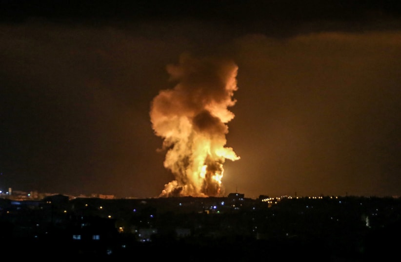 A ball of fire and smoke rises during Israeli airstrikes in Rafah, in the southern Gaza Strip on May 10, 2021. (photo credit: ABED RAHIM KHATIB/FLASH90)