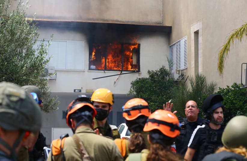 Israeli security forces at the scene where a home was hit by a rocket fired from the Gaza Strip in Ashdod, southern Israel, on May 11, 2021. (photo credit: FLASH90)