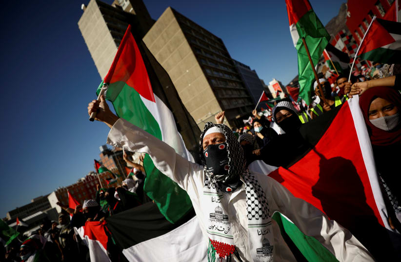 South African demonstrators carry placards during a protest following clashes between Palestinians and Israeli police at Al Asqa Mosque in Jerusalem, outside parliament in Cape Town, South Africa, May 11, 2021. (photo credit: MIKE HUTCHINGS / REUTERS)