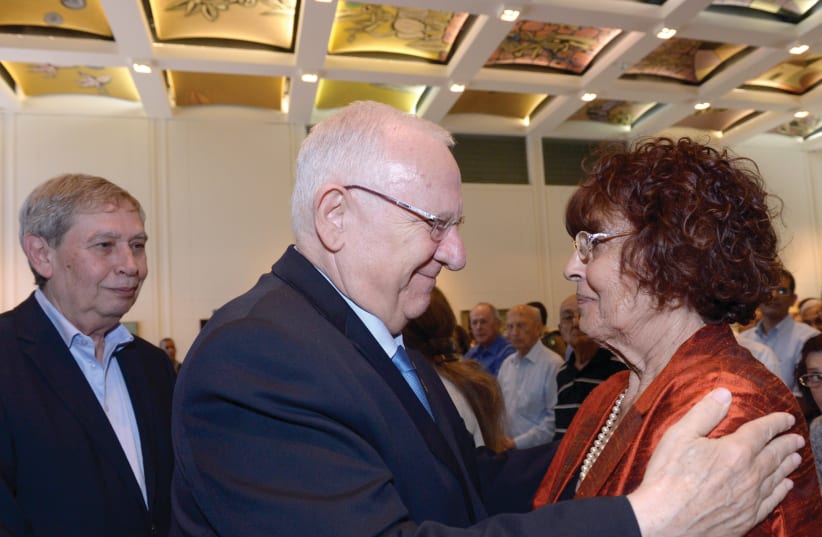 PRESIDENT REUVEN RIVLIN greets Nadia Cohen, the widow of Israeli spy Eli Cohen, at the President’s Residence in 2018. On the left is former Mossad head Tamir Pardo. (photo credit: HAIM ZACH/GPO)