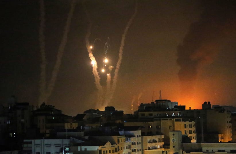 Rockets are launched by Palestinian militants into Israel, in Gaza May 12, 2021. (photo credit: REUTERS/IBRAHEEM ABU MUSTAFA)