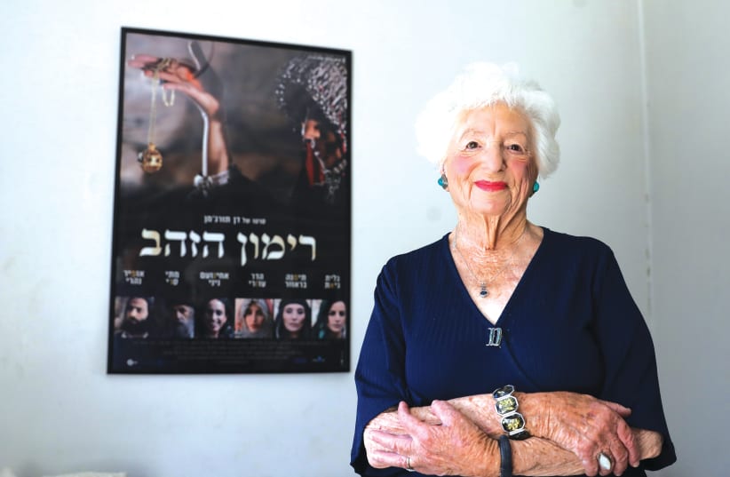 Dvora Waysman in front of the poster for the Hebrew film based on her popular book, ‘The Pomegranate Pendant’ in her Jerusalem apartment. (photo credit: MARC ISRAEL SELLEM)